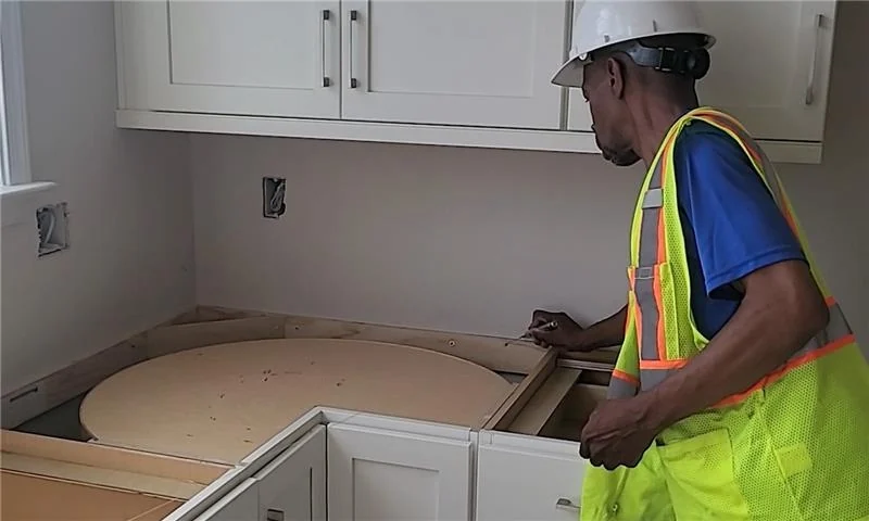 UrbanSource installer working carefully at a countertop installation