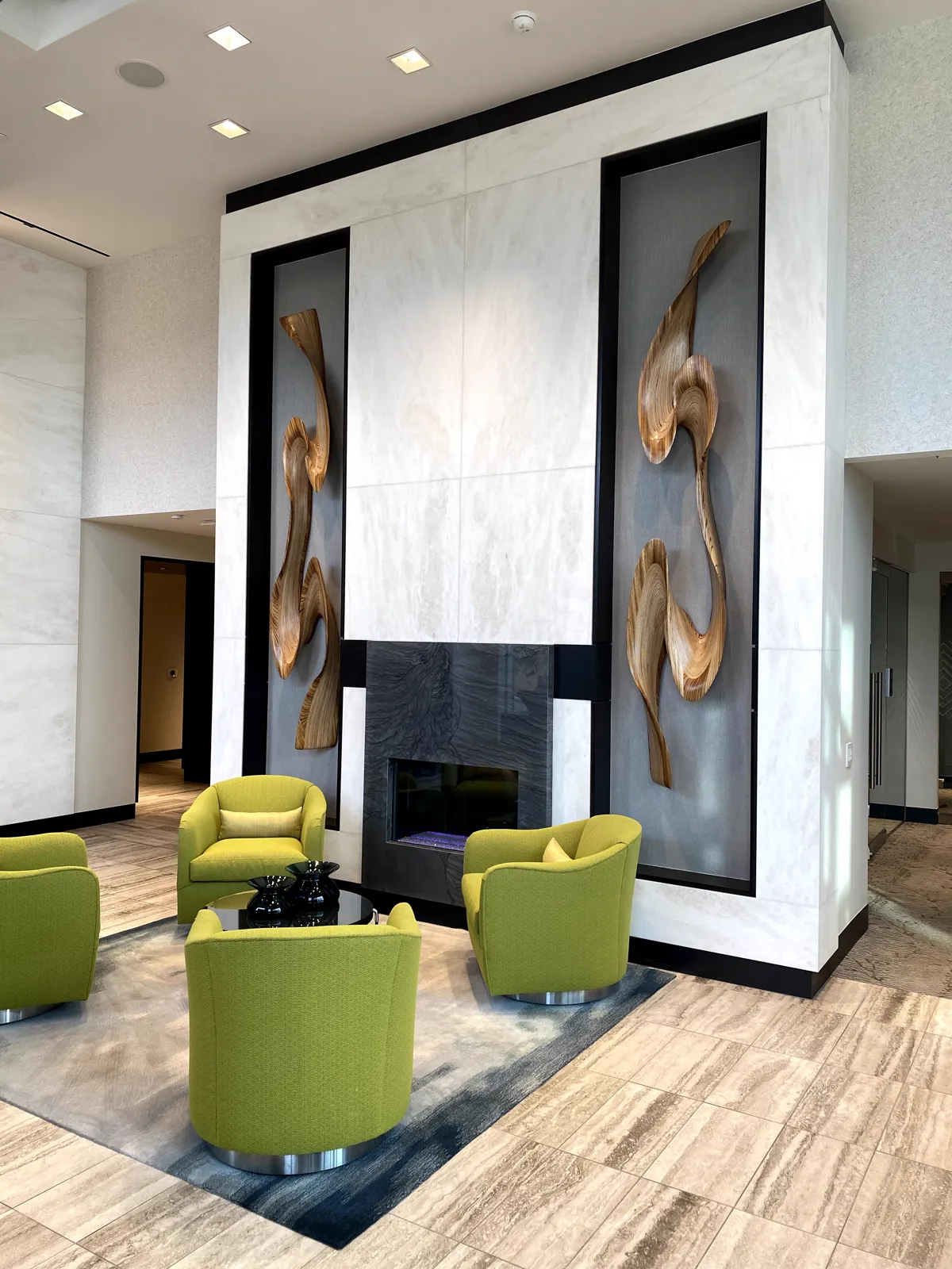 Illuminated dimensional stone fireplace wall at Telek Place
