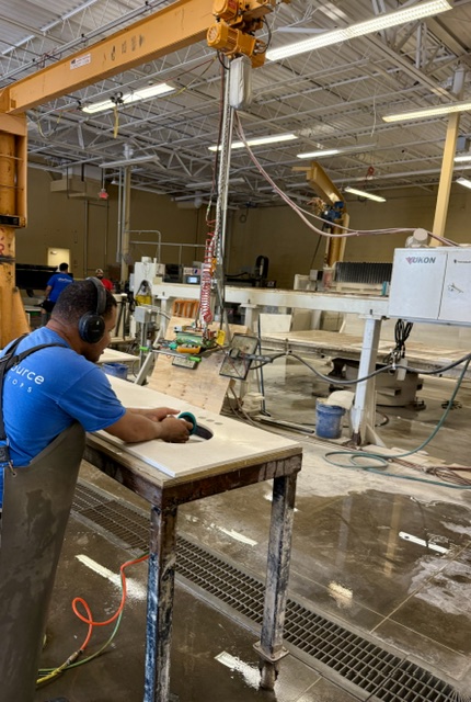 UrbanSource fabricator finishing a countertop sink opening by hand