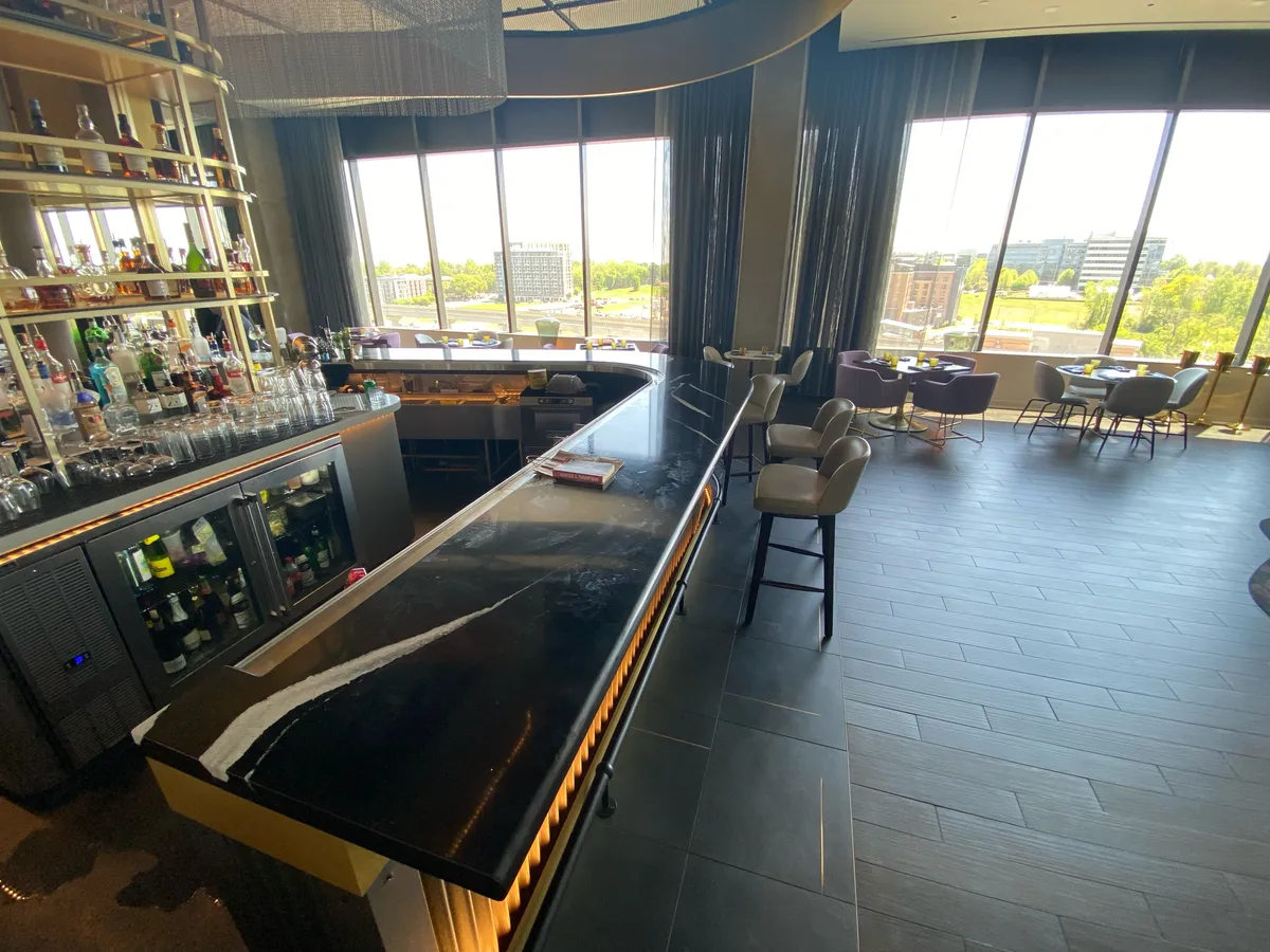 Completed commercial bar with a dark stone counter